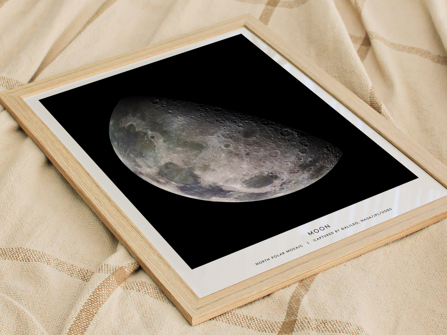 Framed print of the moon on a textured fabric background