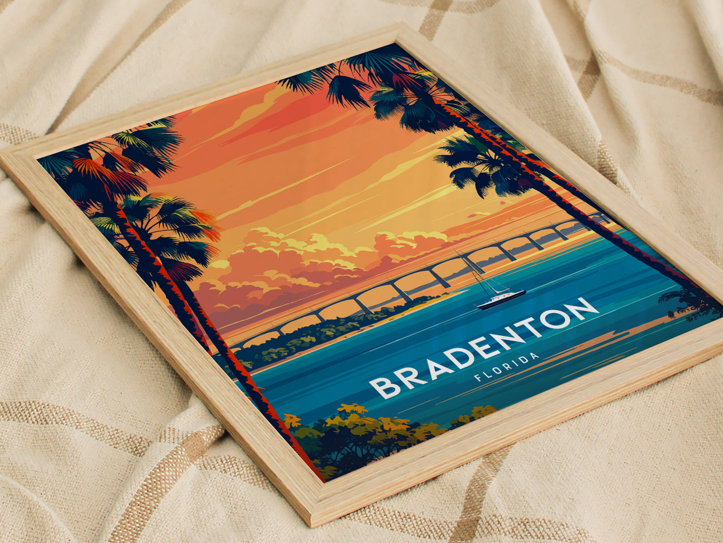 Framed artwork of Bradenton, Florida with a sunset over water and palm trees.