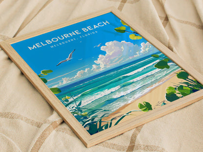 A framed poster of Melbourne Beach, Florida, featuring a vibrant ocean scene with waves, cloudy sky, and seagull. The poster rests on a textured beige fabric.