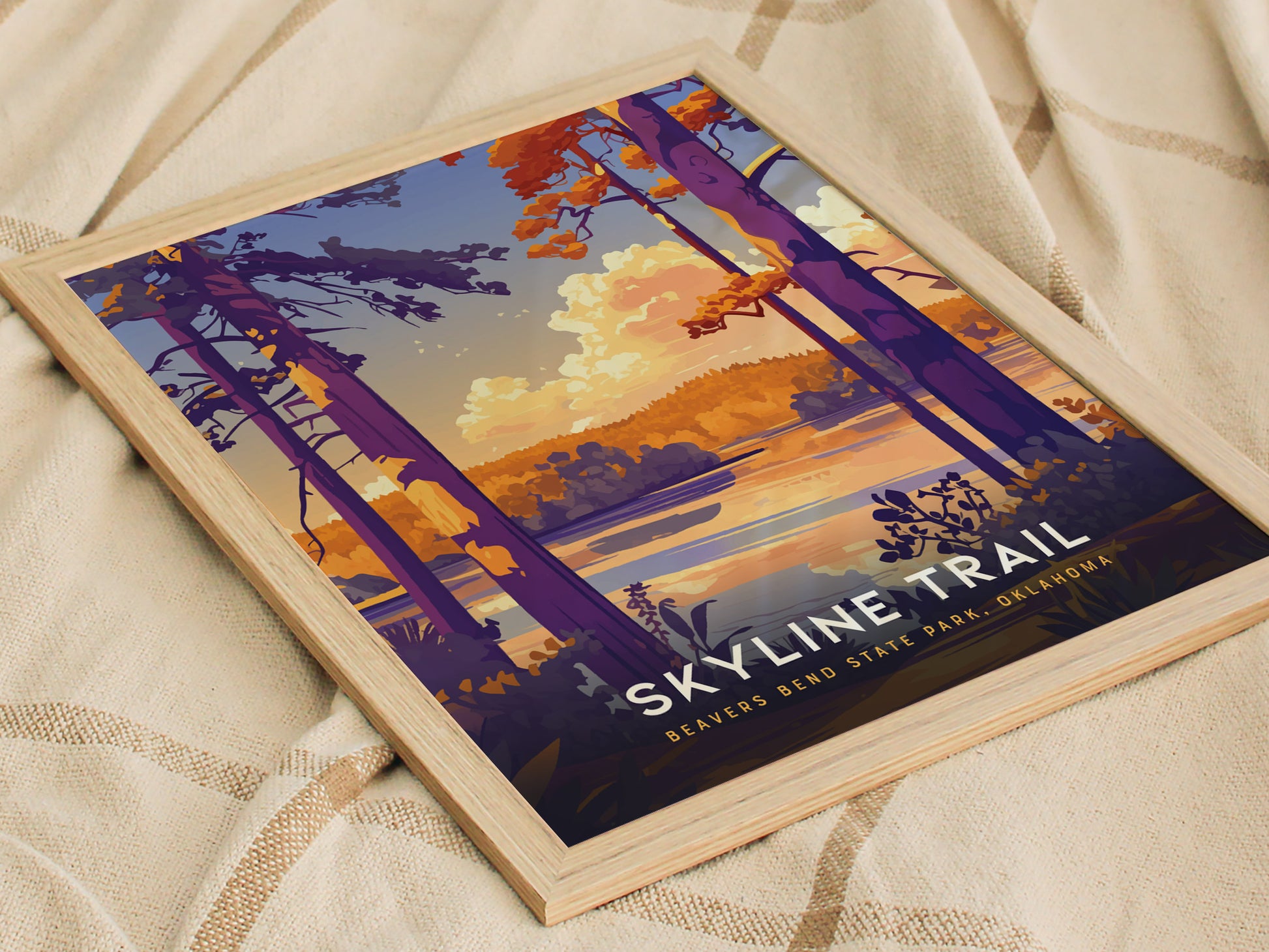 Framed artwork depicting a scenic view of Beavers Bend State Park with vibrant purple trees and a serene lake under a colorful sky, titled Skyline Trail.