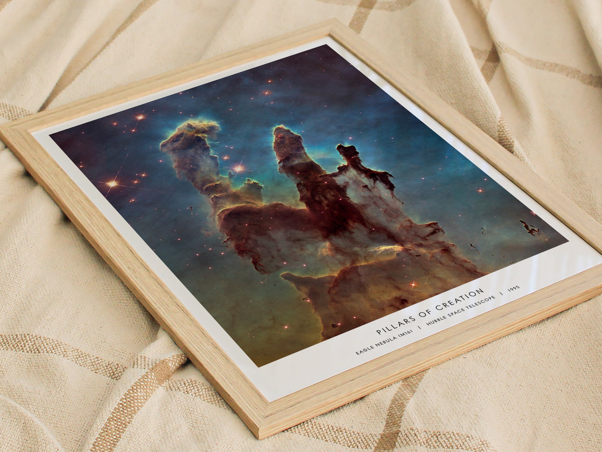 Framed print of 'Pillars of Creation' nebula on a textured surface