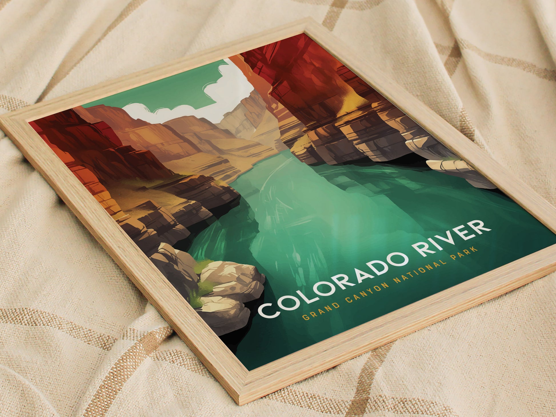 A framed poster displaying an illustrated view of the Colorado River winding through the Grand Canyon, with vibrant colors and bold text reading Colorado River, Grand Canyon National Park.