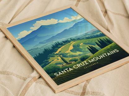 Framed artwork of the Santa Cruz Mountains shows lush vineyards and rolling hills under a vibrant blue sky. The poster is placed on a textured beige fabric.