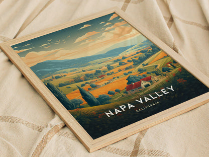 Framed Napa Valley travel poster featuring rolling vineyards, tree-lined hills, and a warm sunset sky. The artwork is set against a soft, textured fabric background.