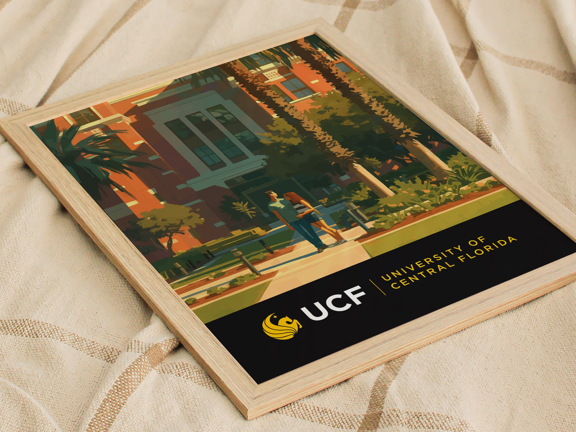 Framed poster featuring an artistic depiction of the University of Central Florida campus, showcasing palm trees, modern architecture, and students walking. Text reads UCF University of Central Florida.