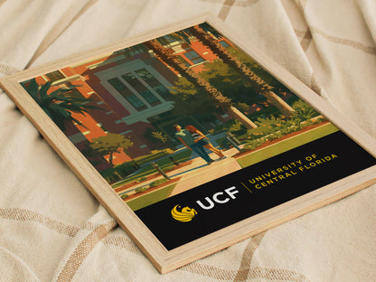 Framed poster featuring an artistic depiction of the University of Central Florida campus, showcasing palm trees, modern architecture, and students walking. Text reads UCF University of Central Florida.