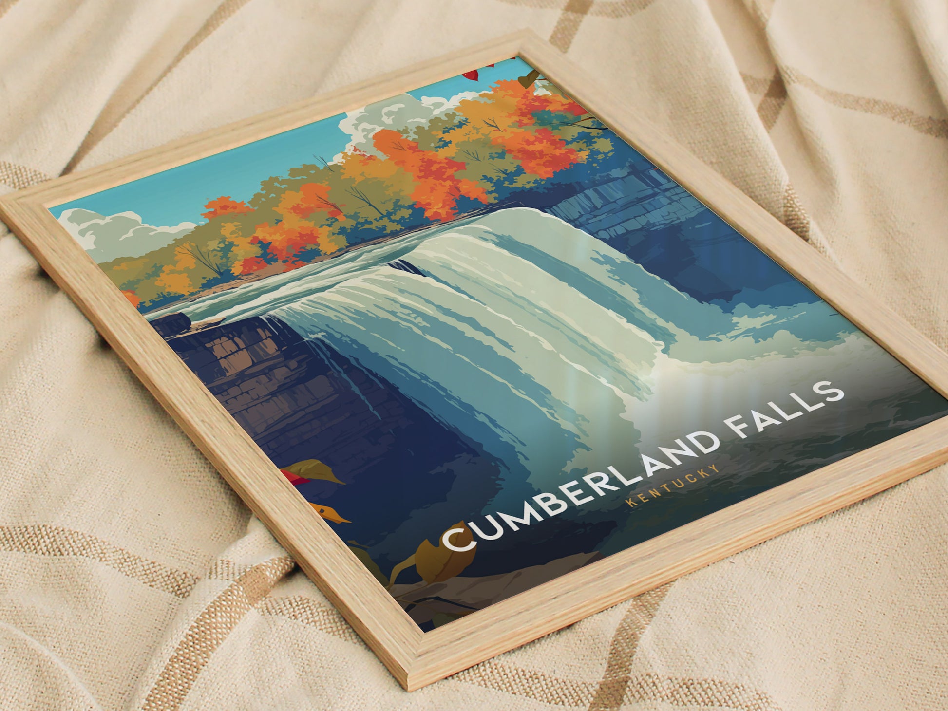 A framed poster of Cumberland Falls in Kentucky features a vibrant illustration of the waterfall surrounded by colorful autumn foliage. The artwork showcases the falls cascading water and highlights the natural beauty of the area.