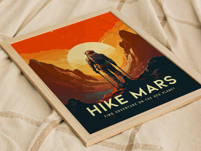 A retro-style poster titled Hike Mars features an astronaut standing on rugged Martian terrain against a vivid orange sky and large sun, framed in light wood.