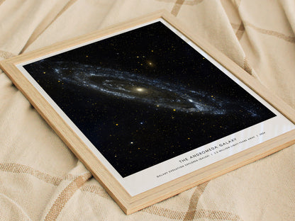 Framed print of 'The Andromeda Galaxy' on a textured fabric background