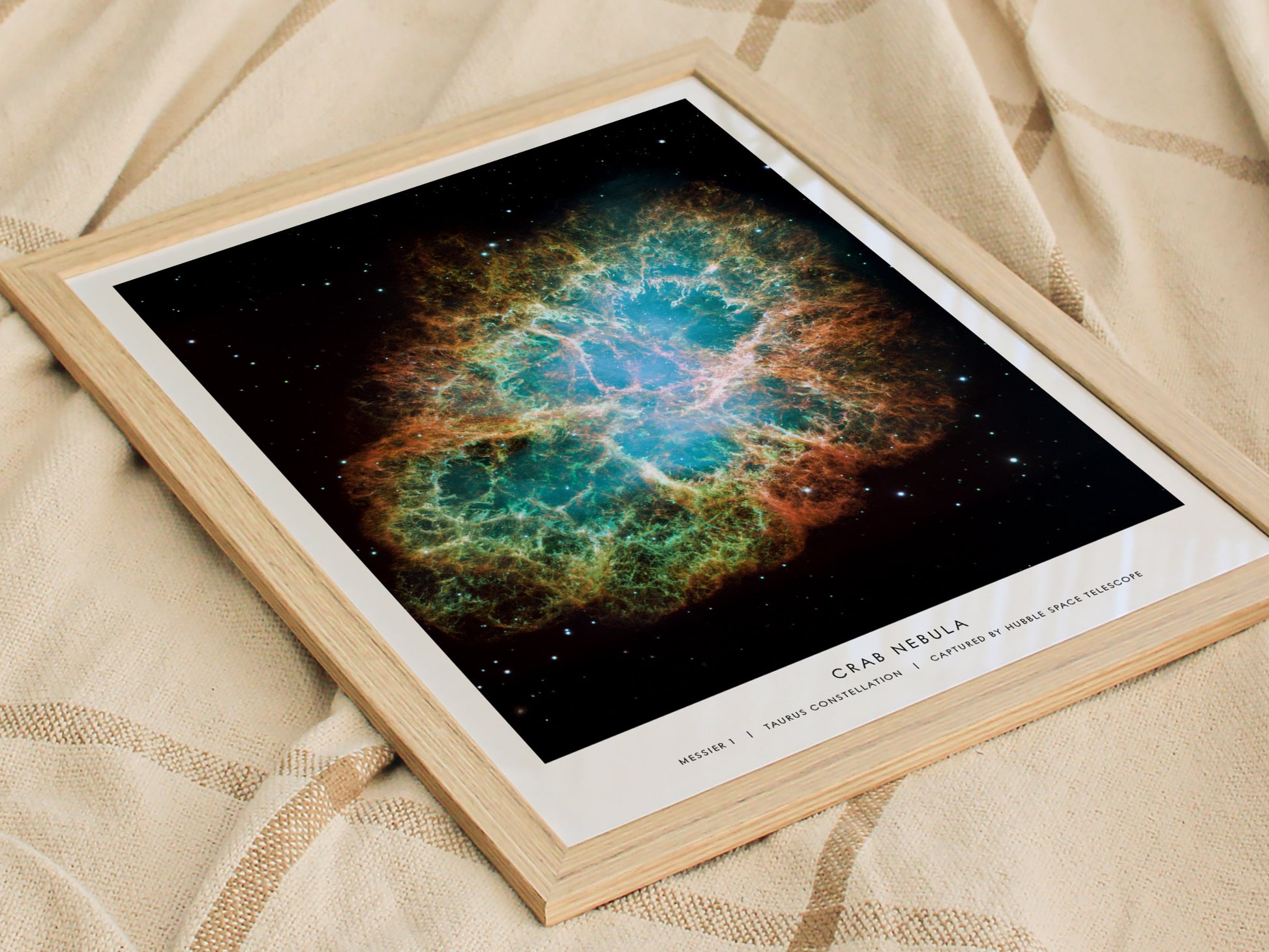 Framed print of the Crab Nebula on a textured fabric background