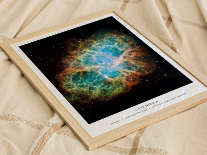 Framed print of the Crab Nebula on a textured fabric background