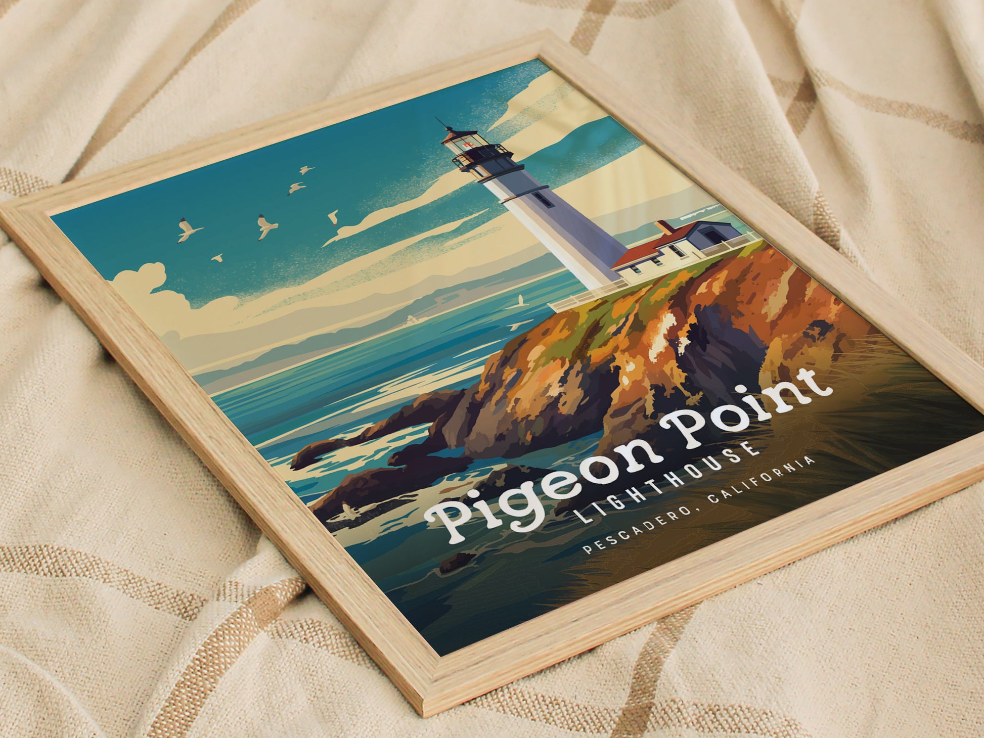 Framed poster of Pigeon Point Lighthouse on a rocky cliff, set against a blue sky with seagulls. Text reads Pigeon Point Lighthouse, Pescadero, California.