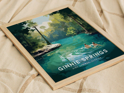 Framed artwork of Ginnie Springs, Florida, depicting two people wading in turquoise waters surrounded by lush greenery, displayed on a textured beige fabric.