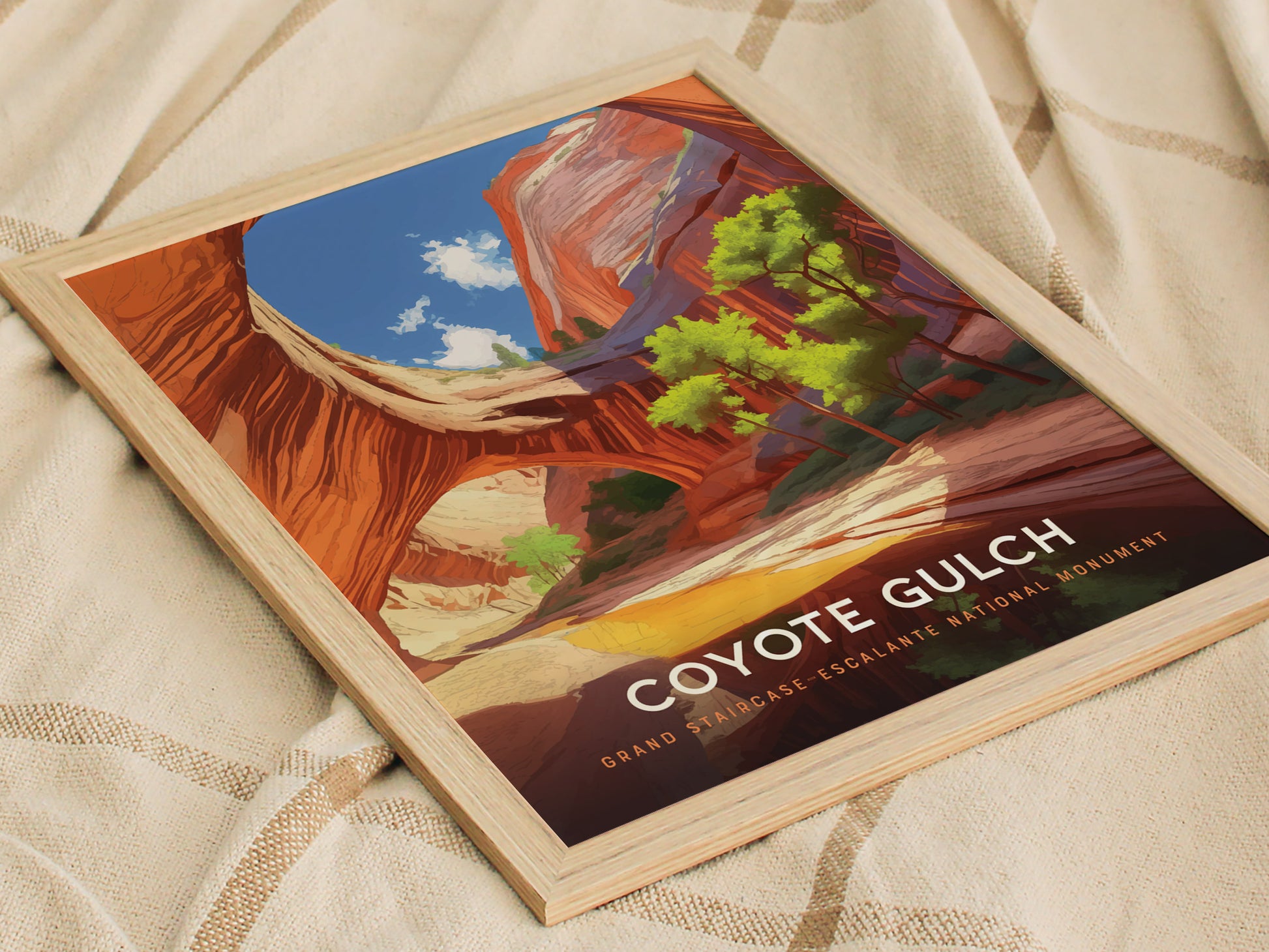 Framed poster depicting Coyote Gulch with vibrant red canyon walls and vivid green trees, set against a bright blue sky. The text reads Coyote Gulch, Grand Staircase-Escalante National Monument.