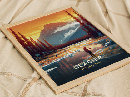 A framed poster of Glacier National Park features a vibrant illustration of mountains, pine trees, and a person standing by a reflective lake at sunset.