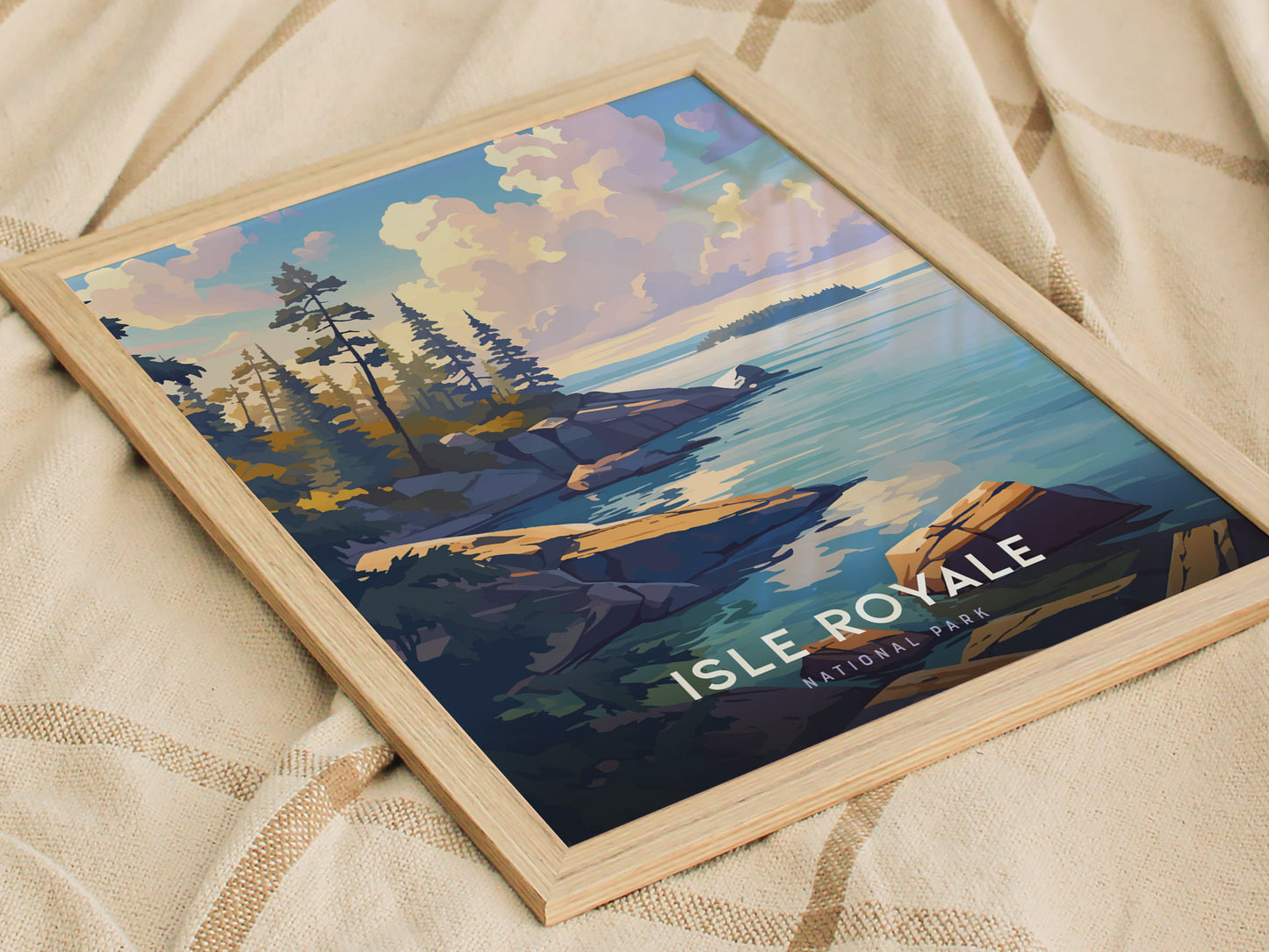 A framed poster depicting Isle Royale National Park features a scenic view of rocky shorelines, tall trees, and calm blue waters under a vibrant sky.
