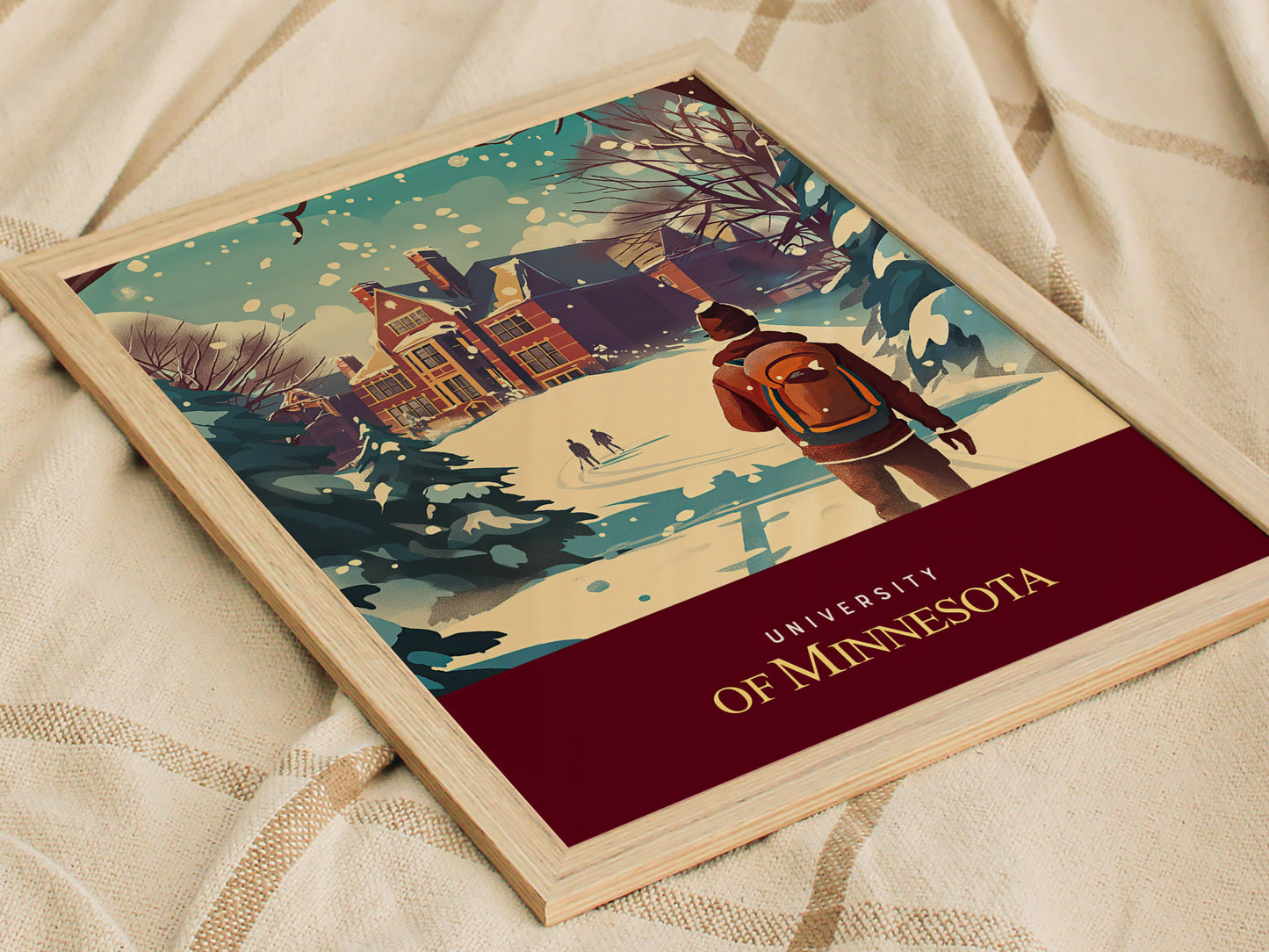 A framed poster shows a winter scene at the University of Minnesota, featuring a student with a backpack walking through snow towards a building, with trees in the background.