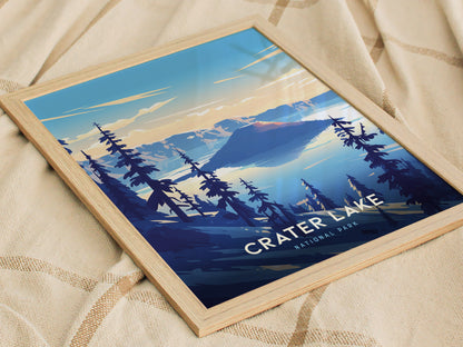 Framed poster of Crater Lake National Park features a stylized landscape with deep blue water, surrounding mountains, and silhouetted trees, resting on a textured beige fabric.
