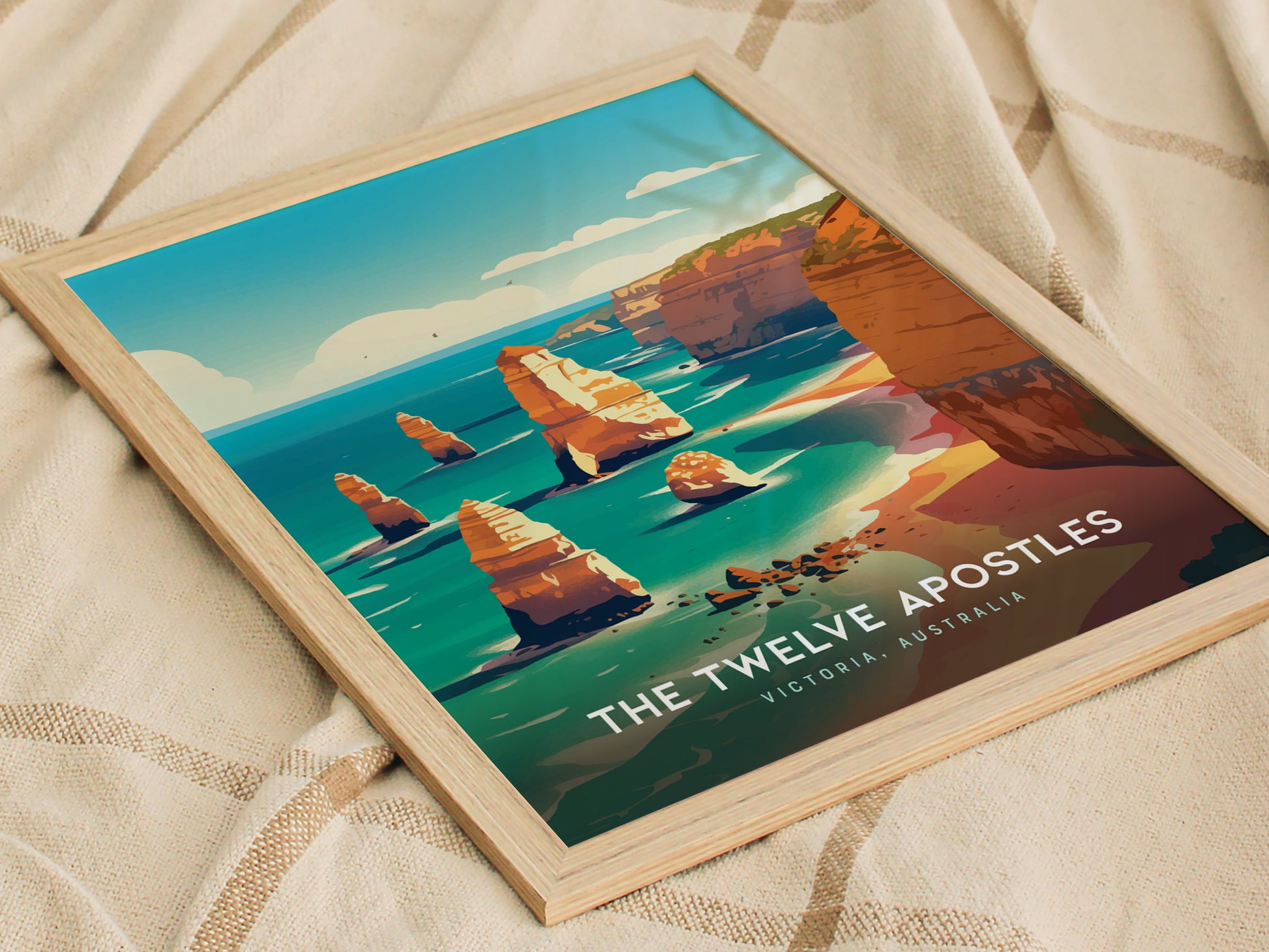 A framed poster of the Twelve Apostles features vibrant illustrations of limestone stacks along the ocean under a blue sky. Text reads The Twelve Apostles, Victoria, Australia.