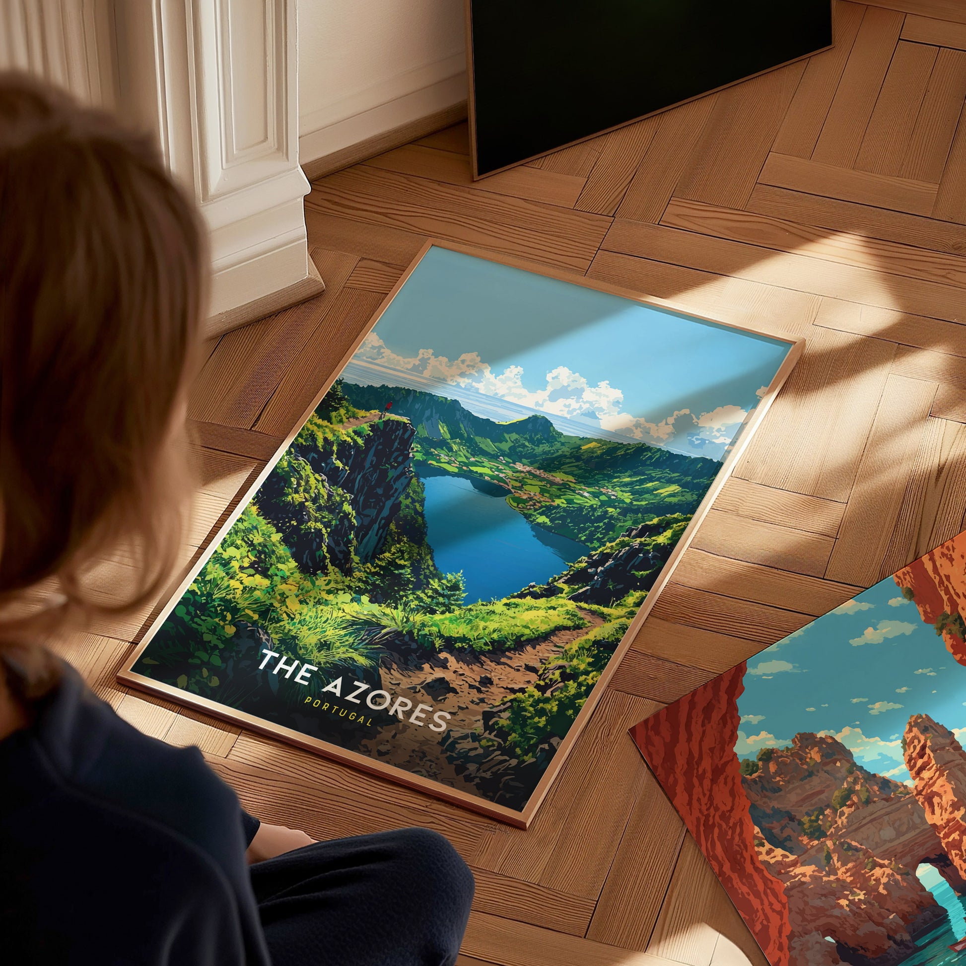 Person looking at a poster of The Azores on a wooden floor