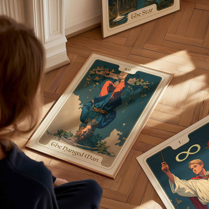 A person sits on a wooden floor, observing a The Hanged Man tarot card illustration featuring an upside-down figure. Sunlight casts soft shadows across the scene.