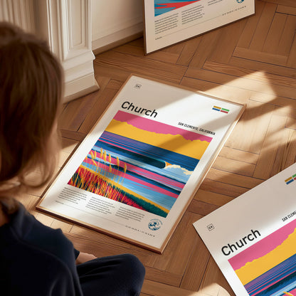 A person sits on a wooden floor, looking at a vibrant poster featuring stylized waves and colorful landscapes, with the title Church prominently displayed.