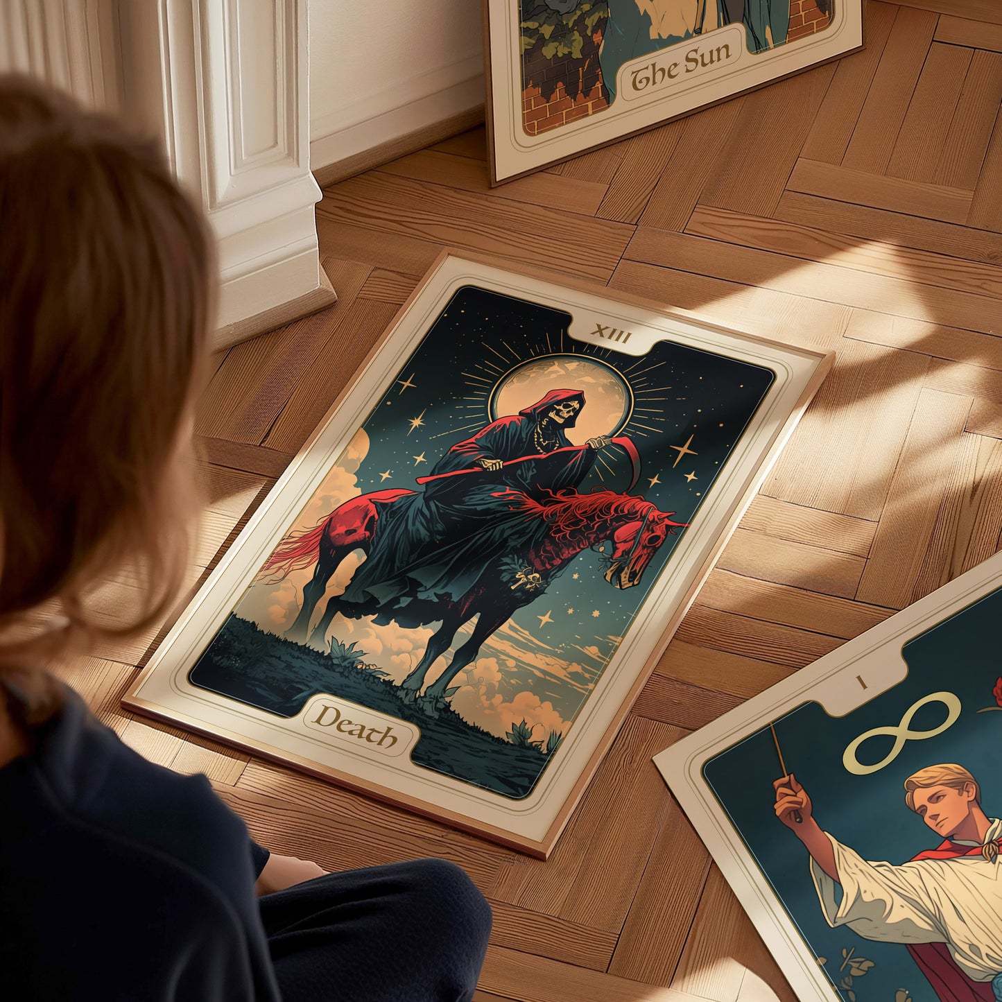 A person observes a tarot poster on the floor featuring the Death card, depicting a skeletal figure on horseback under a starry sky. Other tarot cards are nearby.