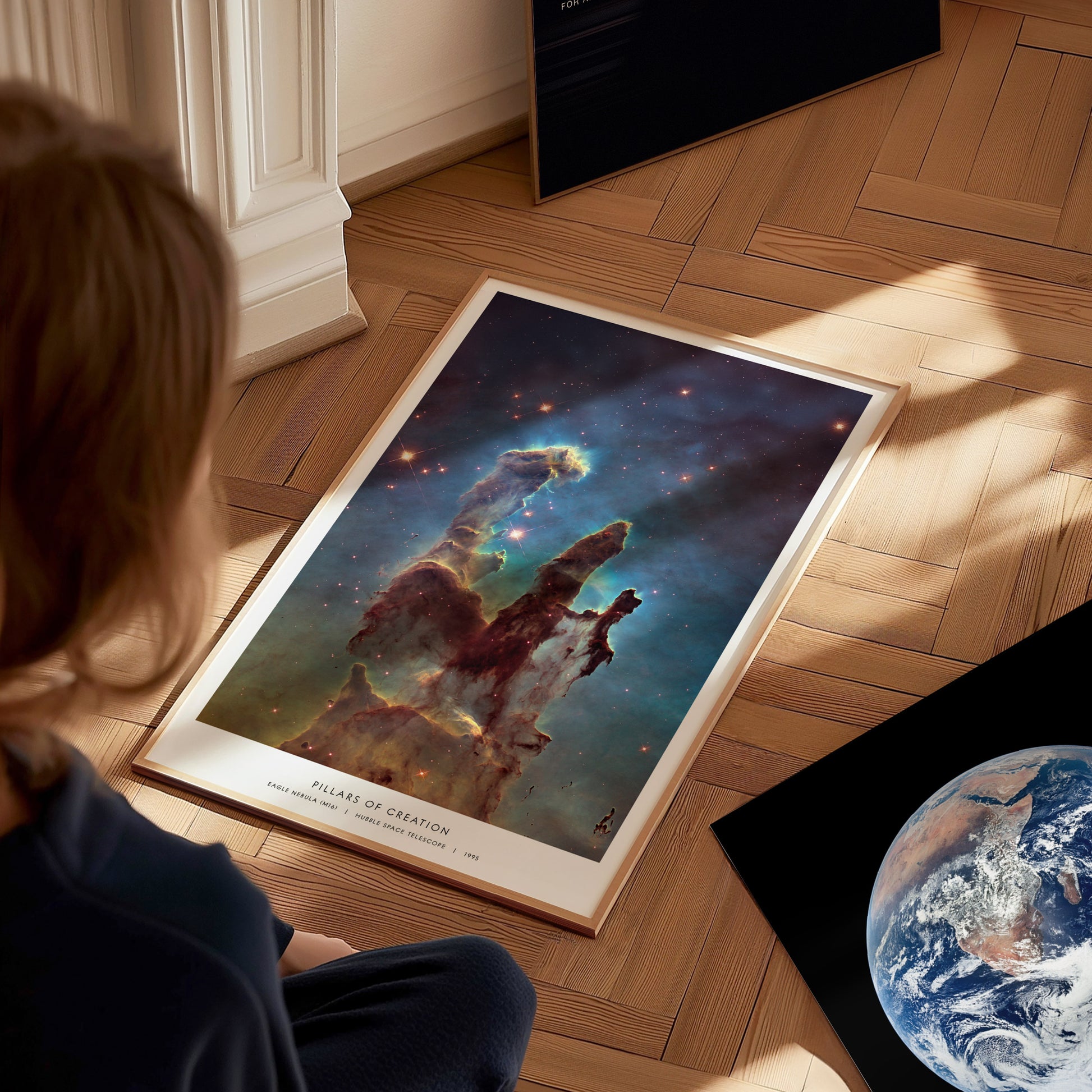Large Pillars of Creation Hubble poster displayed in a study or classroom with science posters