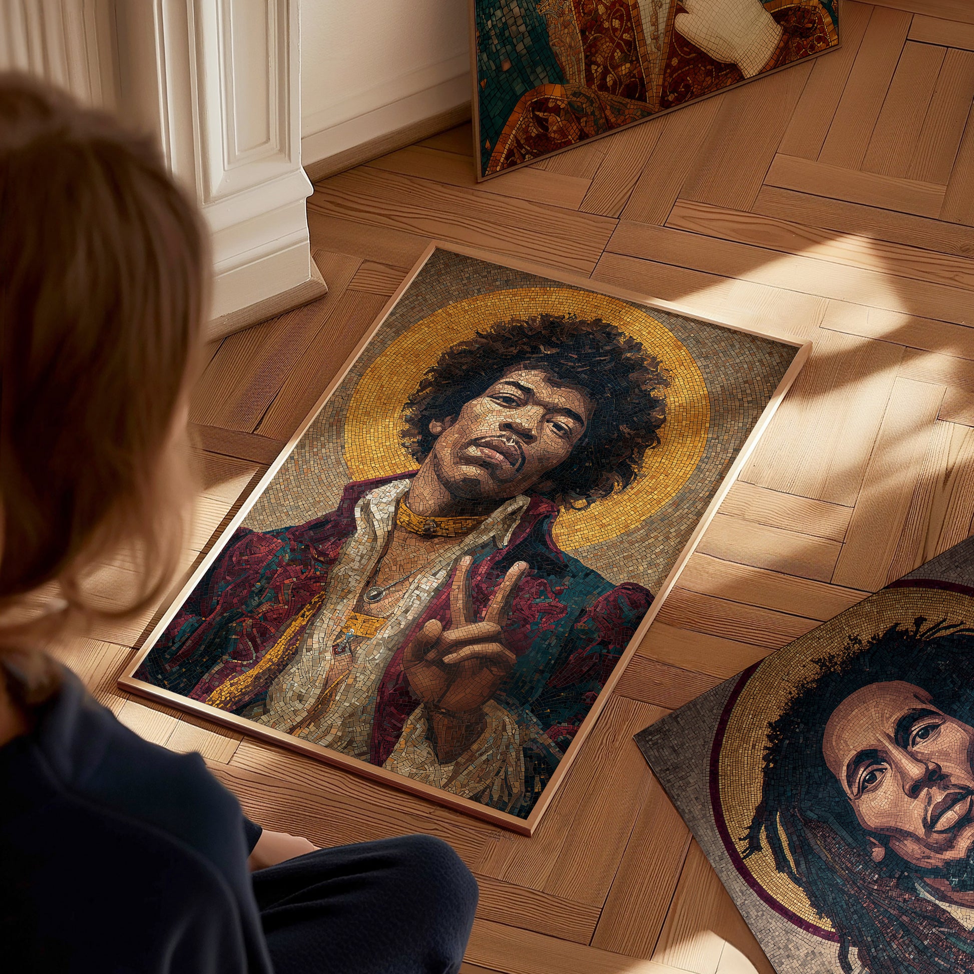 A child sits on a wooden floor, gazing at a framed mosaic art piece of Jimi Hendrix, adorned in a colorful outfit with a golden halo. Other posters of musicians are scattered nearby, creating an artistic and vibrant atmosphere.