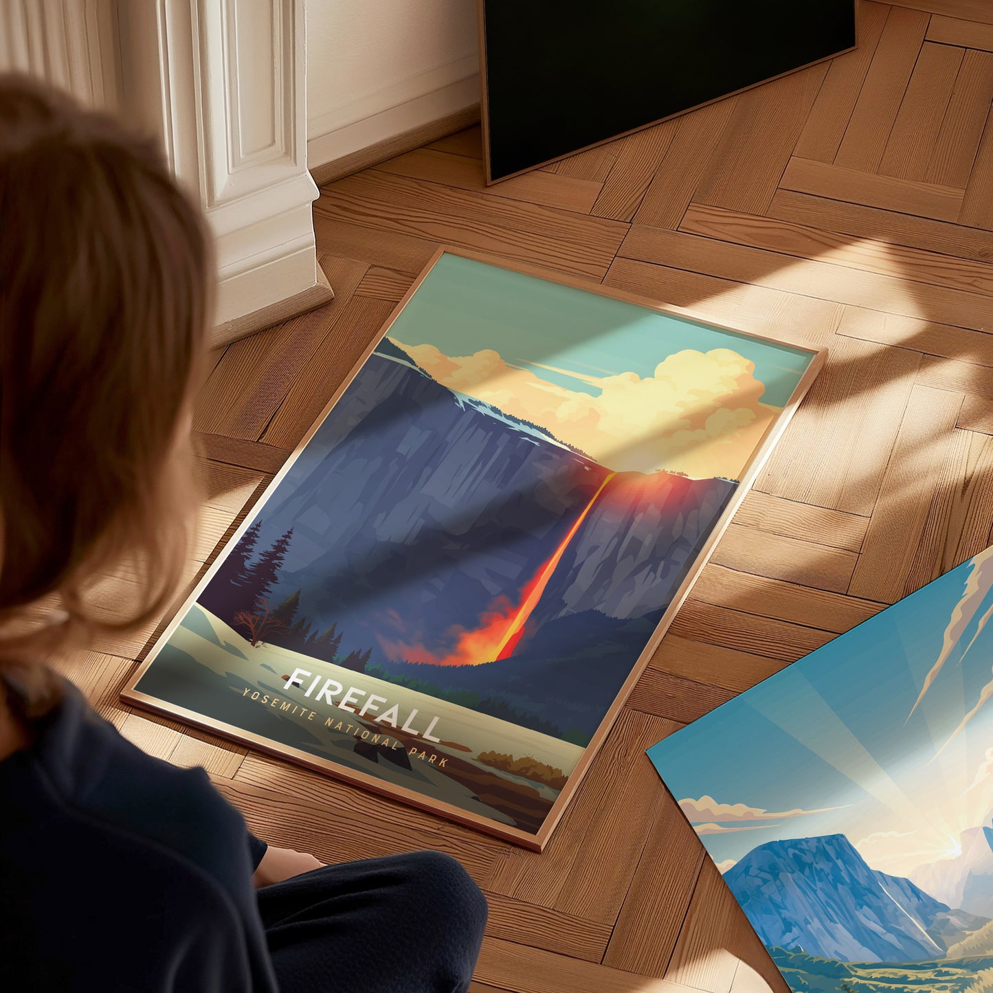 Person sitting on a wooden floor with a mountain-themed poster featuring 'Firefall' design.