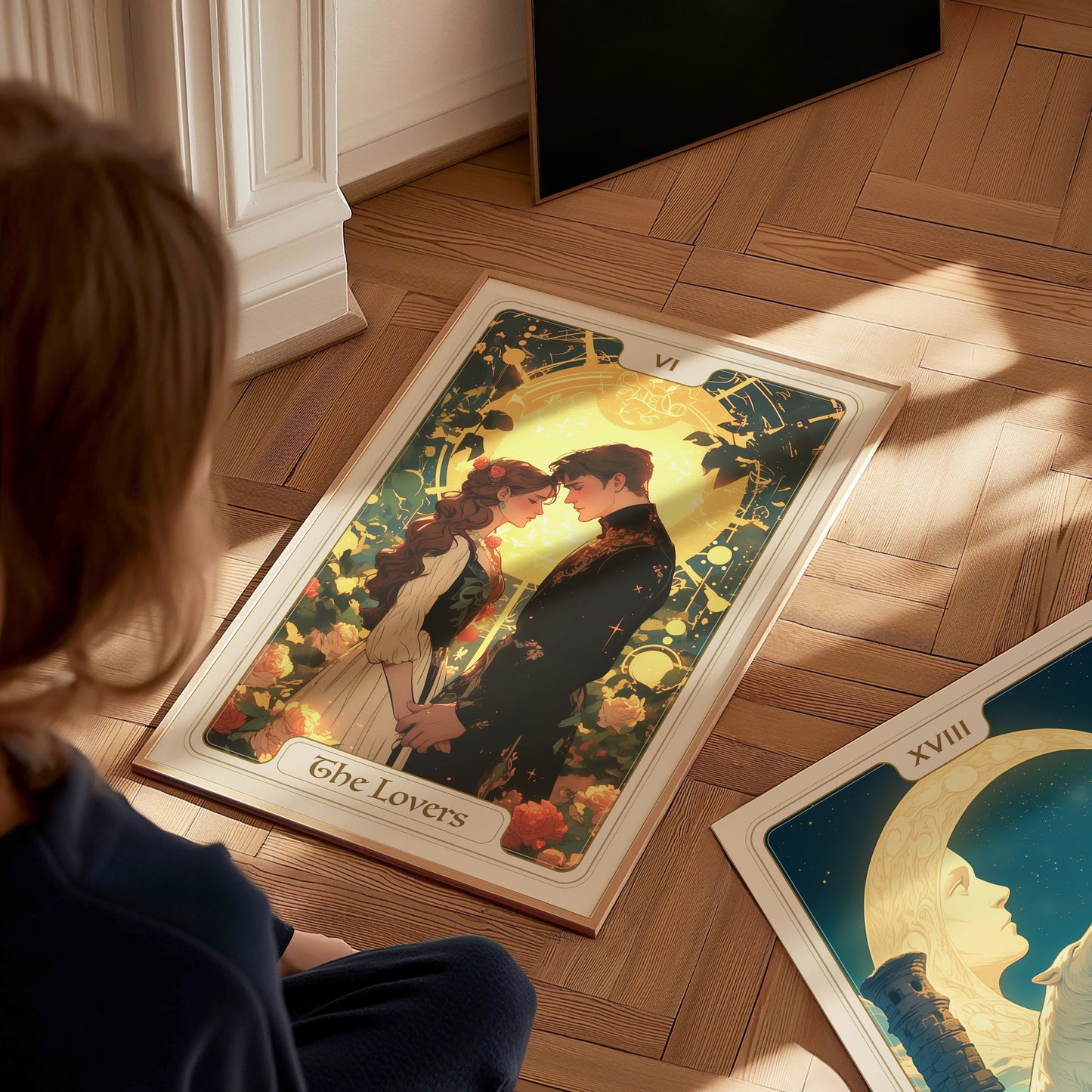 A child sits on a wooden floor, gazing at a vibrant tarot card poster titled The Lovers, featuring two figures embracing amidst a backdrop of flowers and a glowing angel. Another tarot card, labeled XVIII, lies nearby, partially visible.