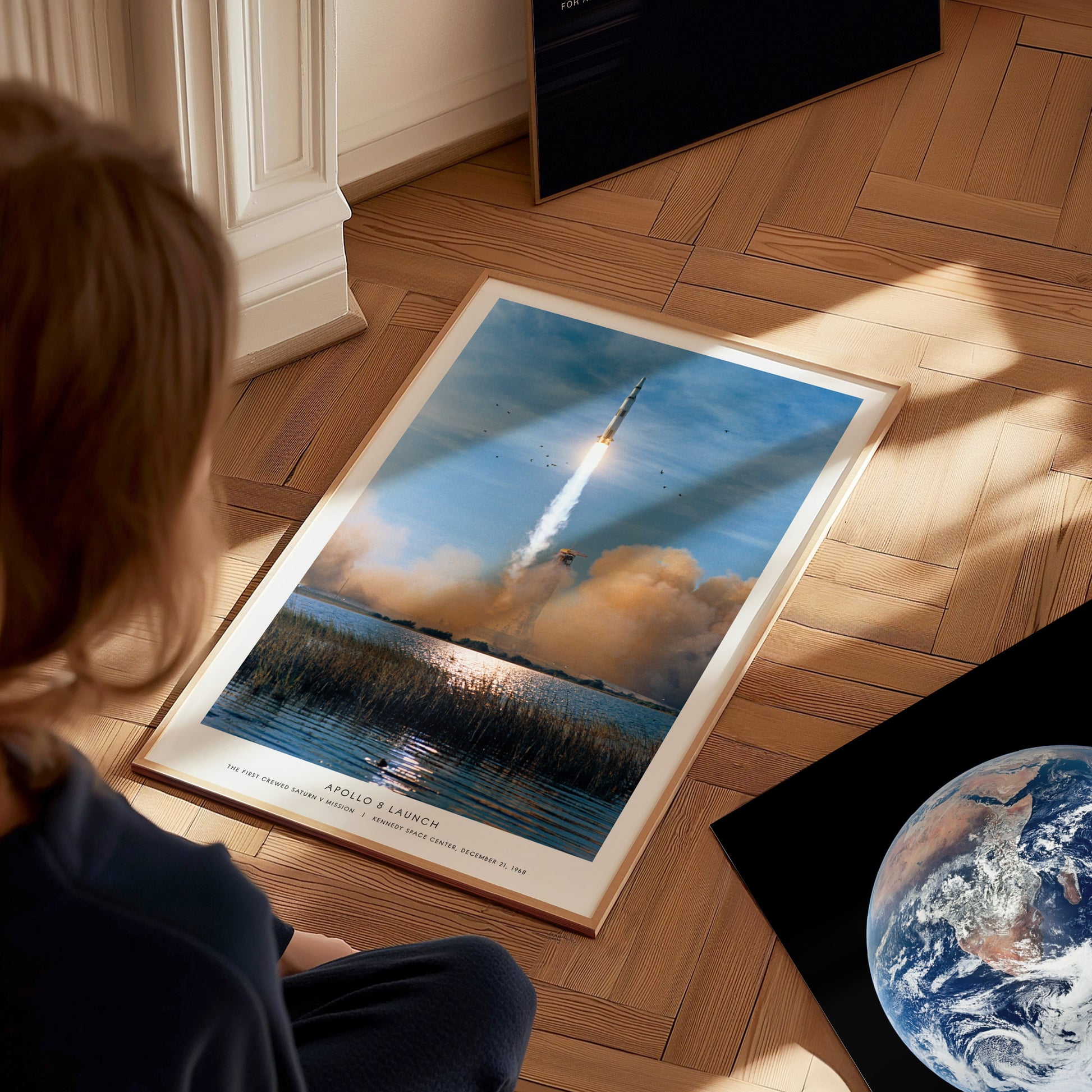 Apollo 8 Saturn V launch wall art used as space themed decor in a study or library