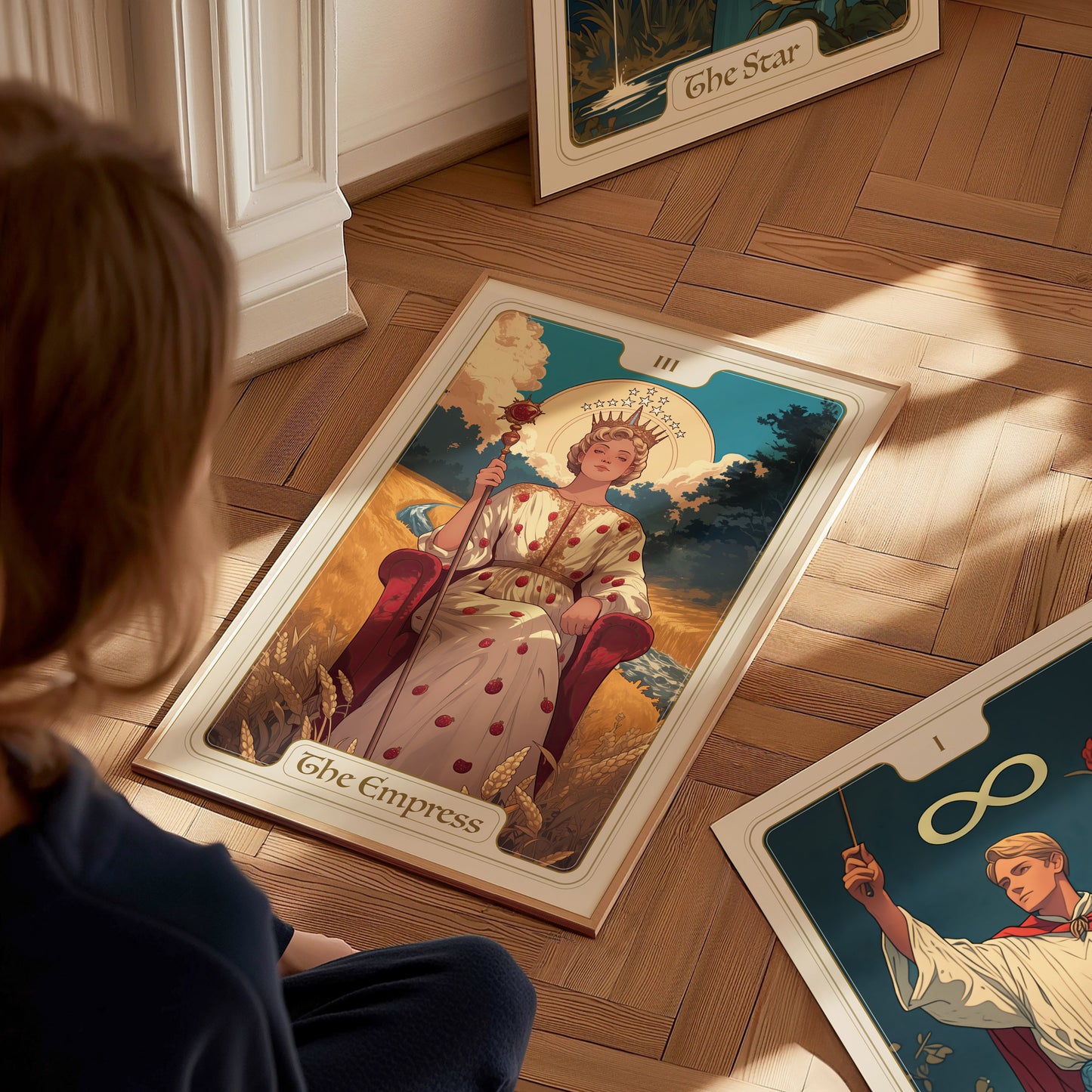 A person looks at a tarot card poster of The Empress, featuring a regal figure seated amid nature, crowned with stars and surrounded by ripe wheat.