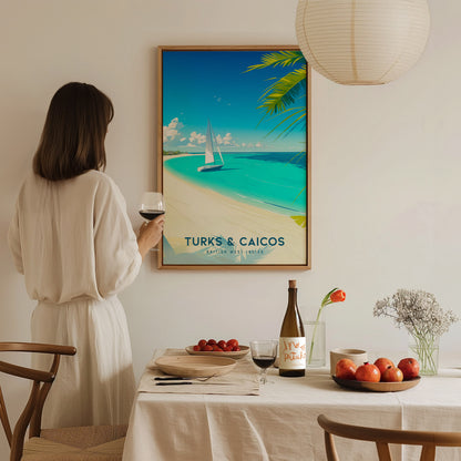A woman in a white blouse stands near a dining table, holding a glass of wine while admiring a colorful wall art print of a beach scene with a sailboat and palm trees, labeled Turks & Caicos.