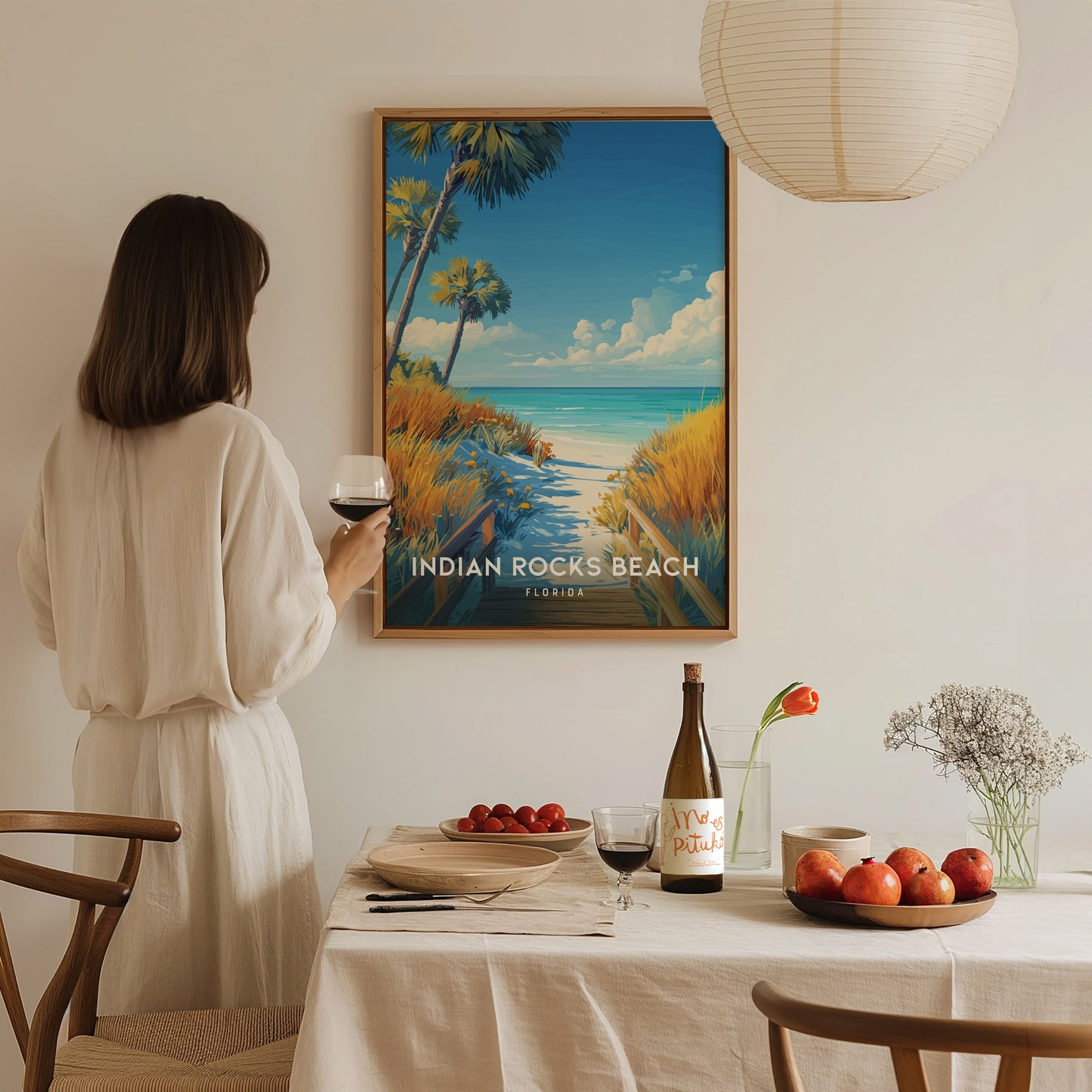 Home setting displaying framed and unframed wall art featuring a serene boardwalk and turquoise waters of Indian Rocks Beach.