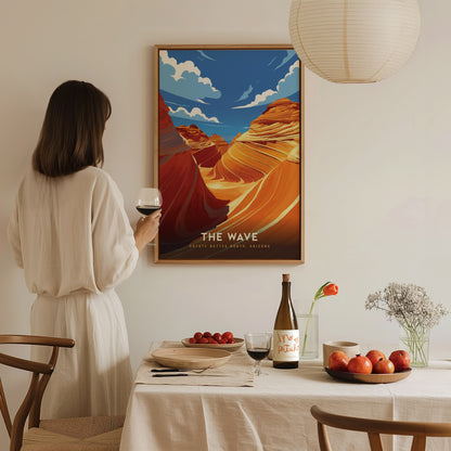 A woman holding a wine glass admires a framed poster of The Wave, featuring vibrant desert formations. The scene includes a dining table with fruits and wine.