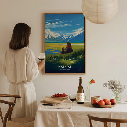 A woman in a white dress admires a Katmai National Park poster featuring bears and mountains. A dining table is set with wine, fruits, and flowers in the foreground.