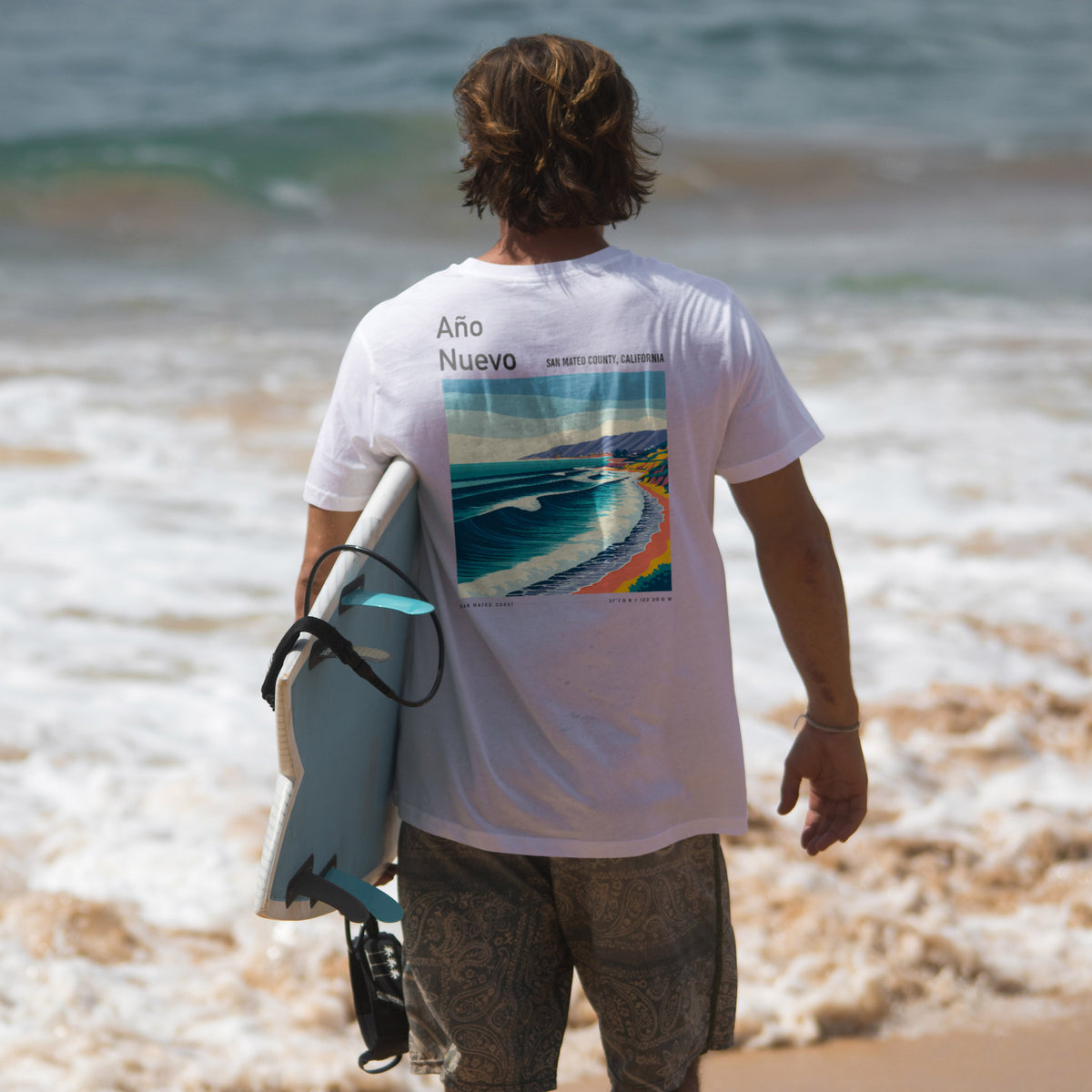Año Nuevo Surf T-Shirt | Wild Coast Wave Art Tee — design printed on the back of the t-shirt